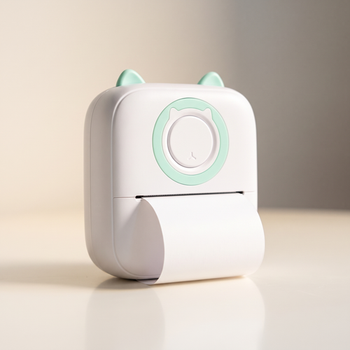 Pocket thermal printer in white with mint detailing, a blank paper strip curling from the front slot