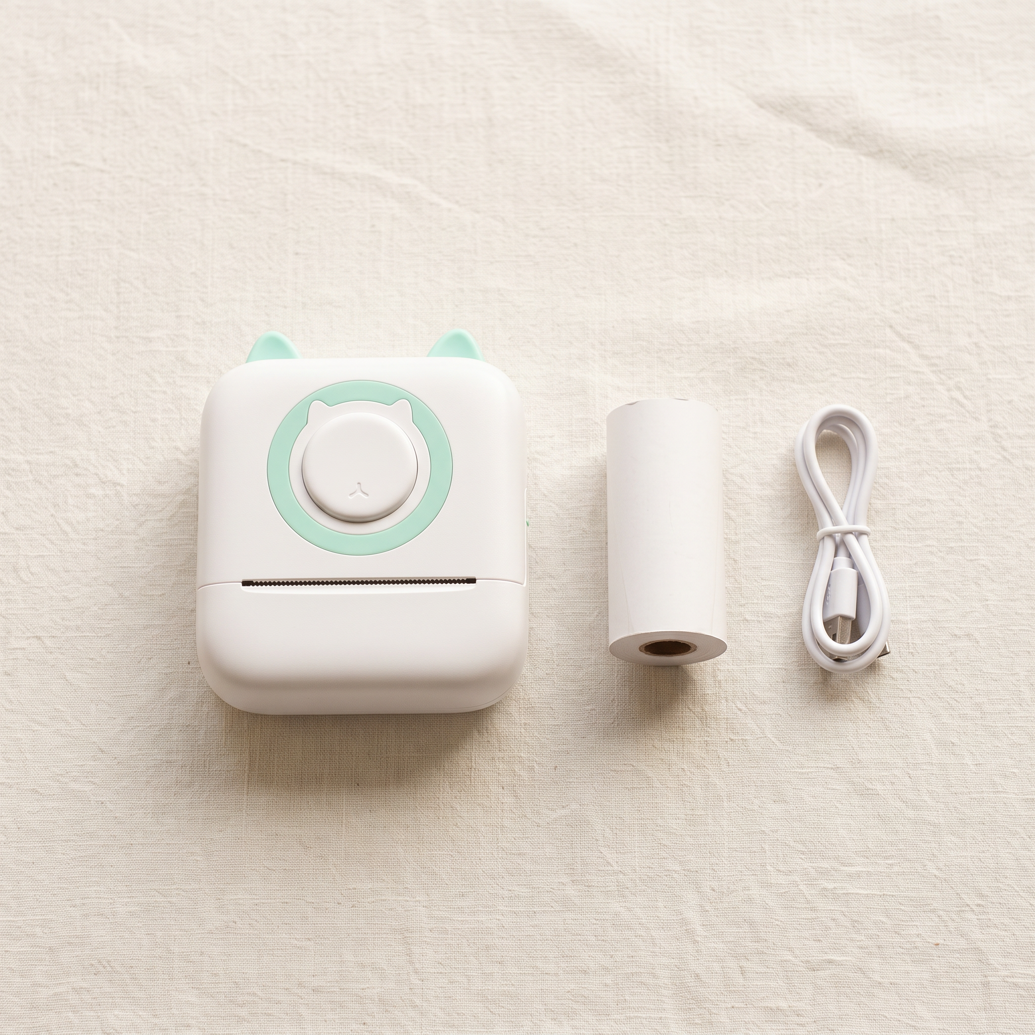 What is in the box: the pocket printer, a roll of thermal paper and a USB cable