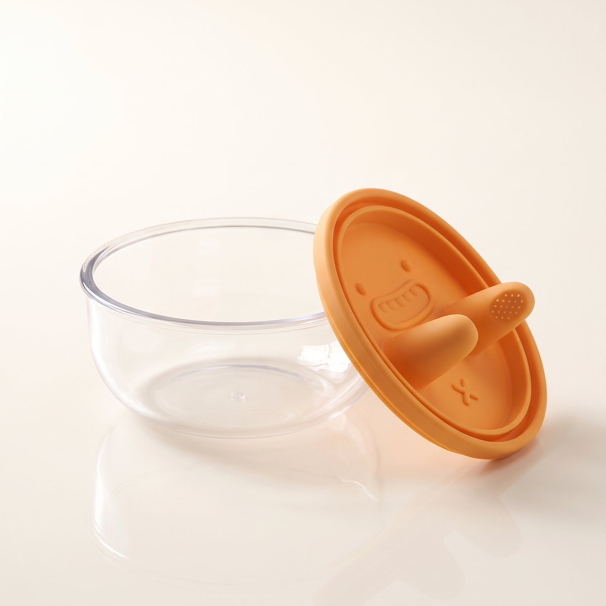 The snack pot open, showing the clear bowl and the orange silicone lid beside it