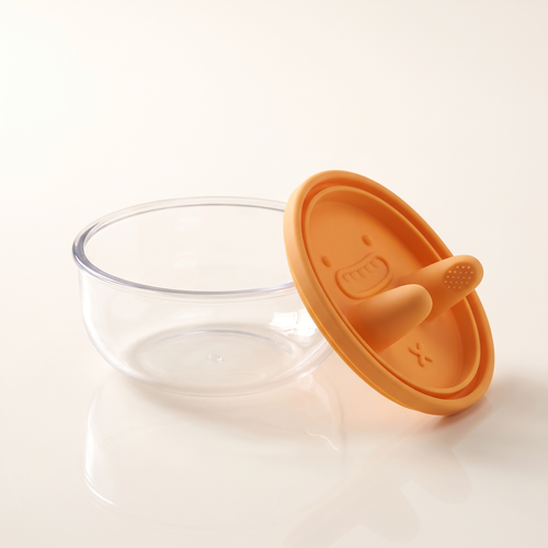The snack pot open, showing the clear bowl and the orange silicone lid beside it