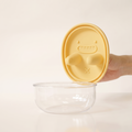 The snack pot with a soft yellow silicone lid