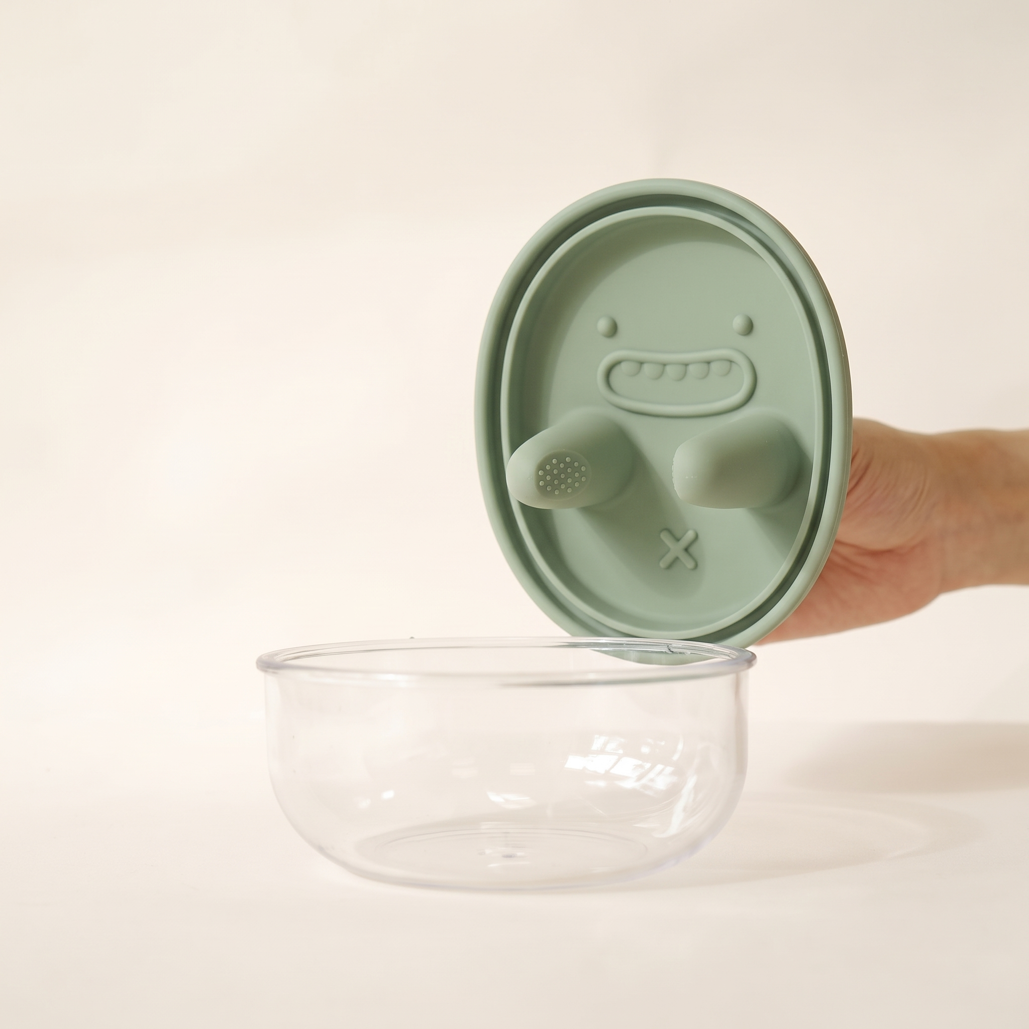 The snack pot with a soft green silicone lid